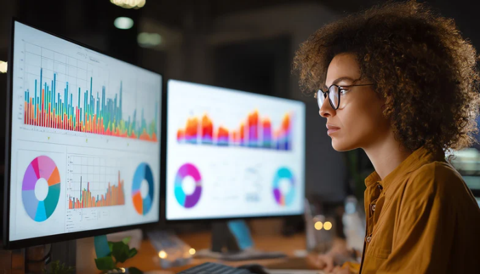 Analyst reviewing complex spreadsheets for oil and gas budget forecasting