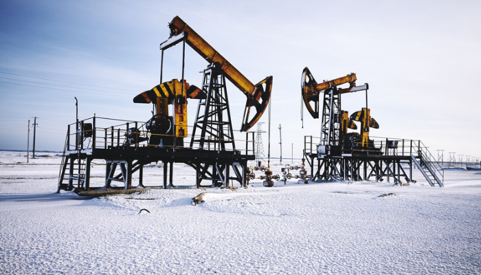 Snow-covered oil wellsite during winter operations